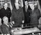 FDR examining a model of the USS Casablanca with Rear Admiral Howard L. Vickery, Henry Kaiser (…