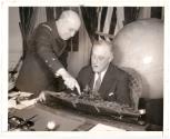 Vice Admiral Raymond A. Fenard presents President Roosevelt with a model of the French battlesh…