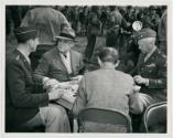 FDR eating from an Army mess kit with Lt. Gen. Mark Clark, Harry Hopkins, and Maj. Gen. George …